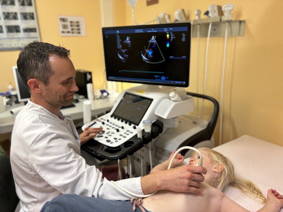 Ein Foto von Chefarzt Dr. Rubarth bei der kardiologischen Ultraschalluntersuchung eines Kindes