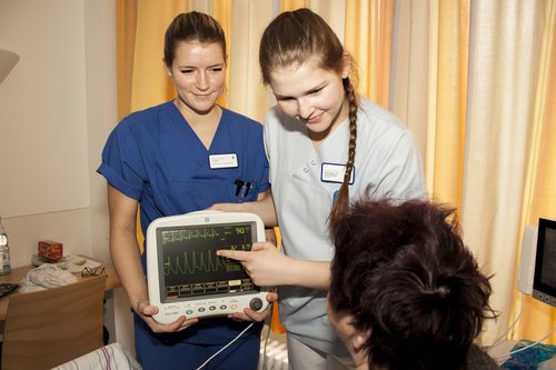 Johanna und Chiara erklären Patientin Karin K. den Monitor der mobilen Telemetrie-Einheit. (Foto: Stefan Mülders)