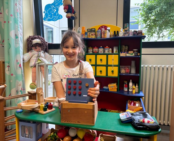 Bild das ein Mädchen im Kaufladen im Spielzimmer in der Klinik für Kinder und Jugendliche zeigt.
